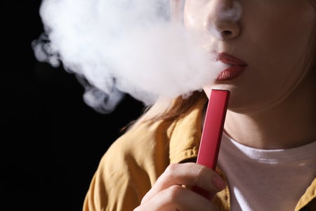 Person smoking with an e-cigarette.