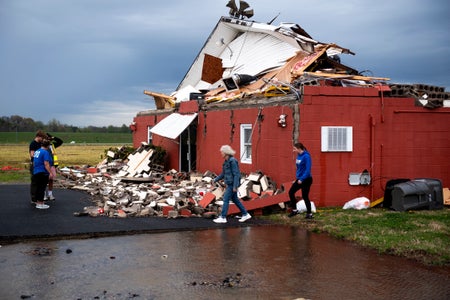 Community members look over damage of a church