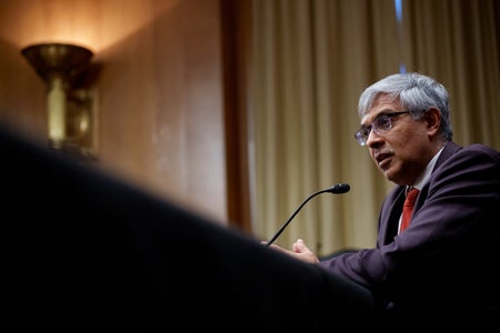 Jay Bhattacharya standing at lectern