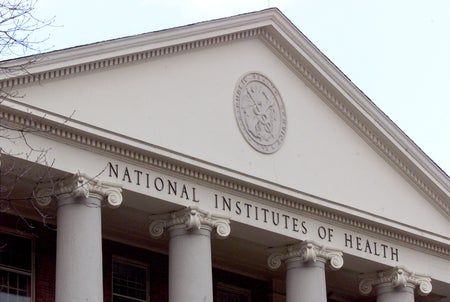 A seal that reads "U.S. Public Health Service" adorns a building on the campus of the National Institutes of Health,