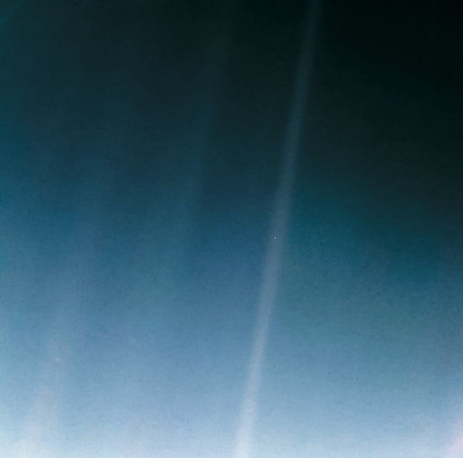 Pale blue dot - Earth as a faint speck in streak of sunlight