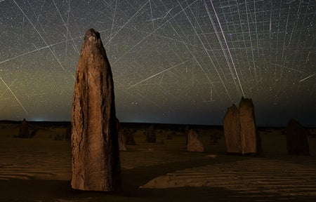 Satellite streaks appear in a photograph taken above the Pinnacles in Nambung National Park, Western Australia.